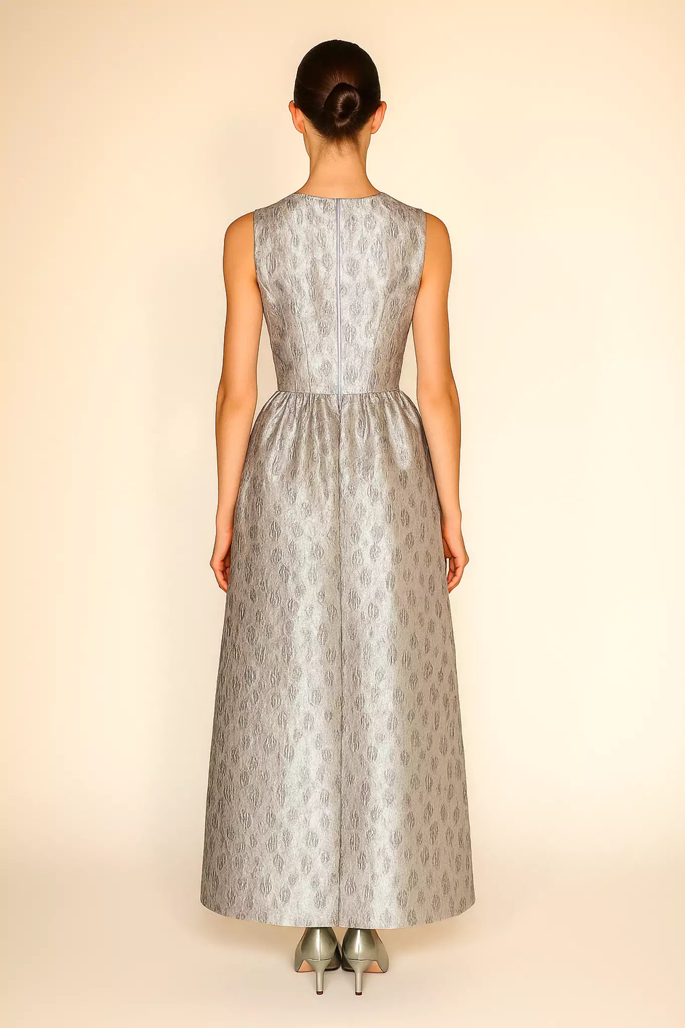 FRAQAIR silver jacquard evening gown, sleeveless design with defined waist, back view on model with sleek bun.