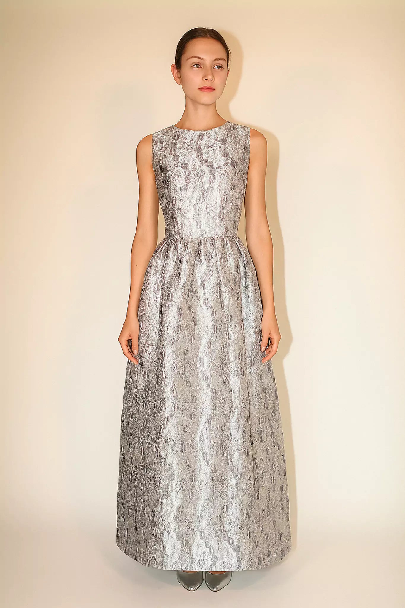 Luxury FRAQAIR silver jacquard maxi dress, sleeveless fitted bodice and flared skirt, front view on model.